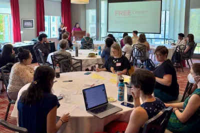 FREE event attendees sitting around tables in conference room